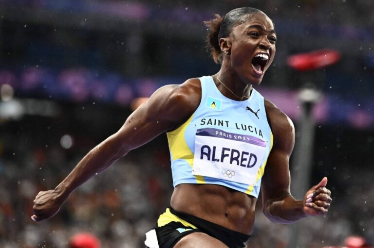 TOPSHOT – Saint Lucia’s Julien Alfred celebrates winning the women’s 100m final of the athletics event at the Paris 2024 Olympic Games at Stade de France in Saint-Denis, north of Paris, on August 3, 2024. (Photo by Jewel SAMAD / AFP) (Image obtained at stluciatimes.com)
